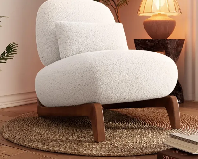 Cloud bouclé chair in off-white with a tilted back and lumbar pillow