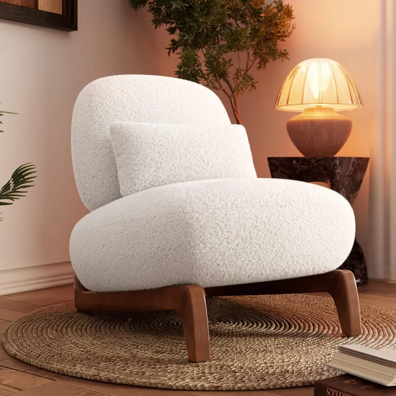 Cloud bouclé chair in off-white with a tilted back and lumbar pillow