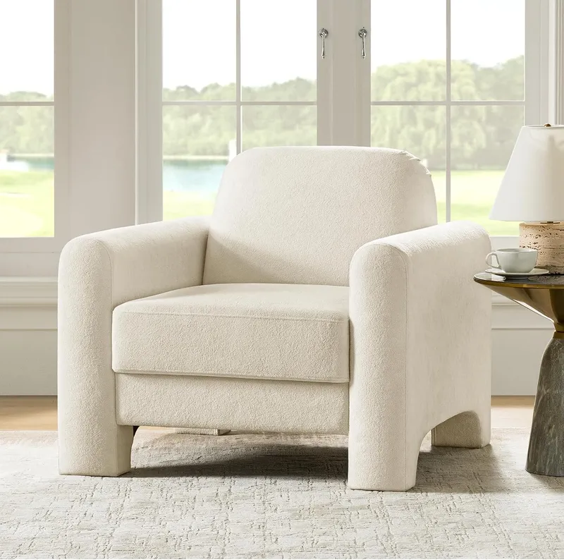 Curved ivory bouclé accent chair with fully wrapped armrests